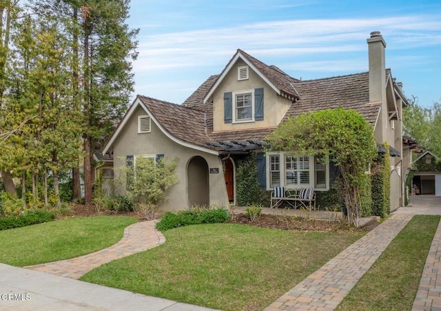 view of front of house featuring a front lawn and stucco siding