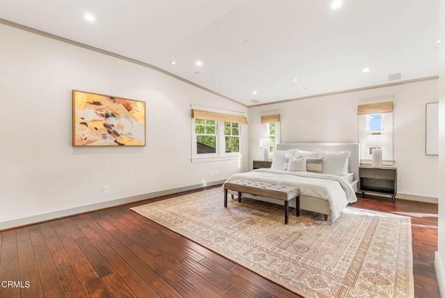 bedroom featuring baseboards, wood-type flooring, visible vents, and crown molding