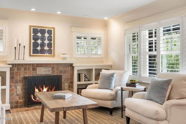 living area featuring a tile fireplace and recessed lighting