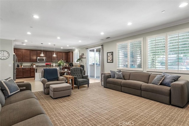 living area with visible vents, ornamental molding, light wood-style flooring, and recessed lighting