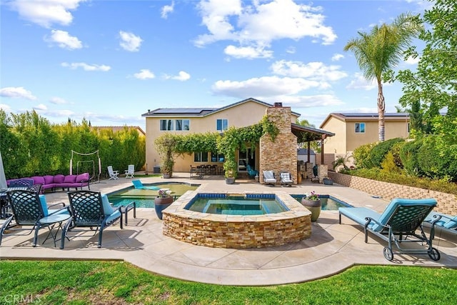 outdoor pool featuring a patio area, an outdoor living space, and an in ground hot tub