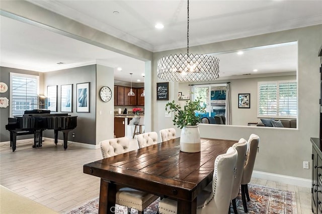 dining space featuring light wood-type flooring, crown molding, baseboards, and recessed lighting