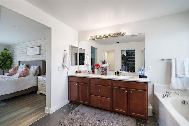 34908 Kooden Rd, Winchester, CA 92596 - bathroom featuring double vanity, a bath, wood finished floors, and connected bathroom