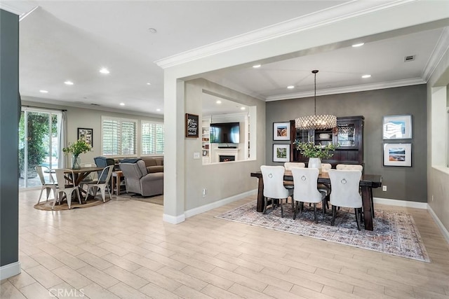 34908 Kooden Rd, Winchester, CA 92596 - dining area featuring baseboards, light wood-type flooring, crown molding, recessed lighting, and a chandelier