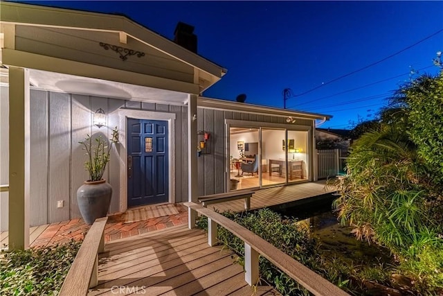 property entrance featuring board and batten siding