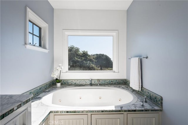 full bathroom featuring a tub with jets