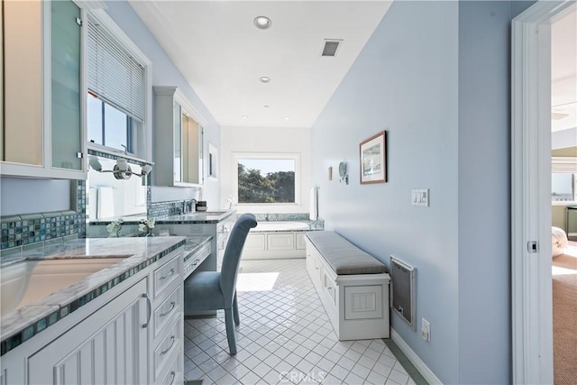 home office featuring light tile patterned flooring, a sink, baseboards, visible vents, and recessed lighting