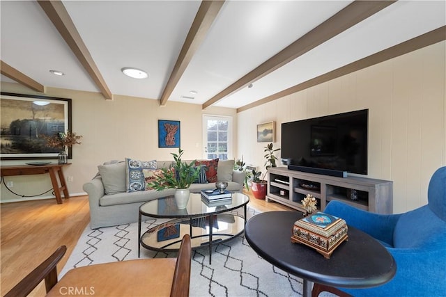 living room with beam ceiling and wood finished floors