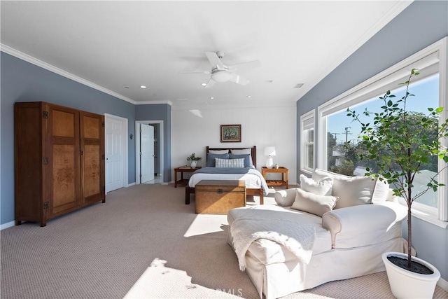 bedroom featuring baseboards, ceiling fan, crown molding, and light carpet