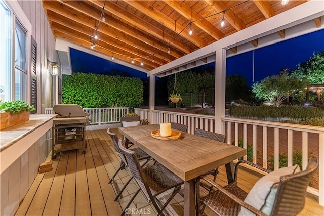 deck at night with outdoor dining space