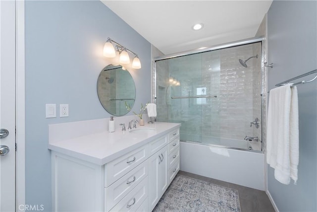 full bath featuring tile patterned floors, combined bath / shower with glass door, and vanity