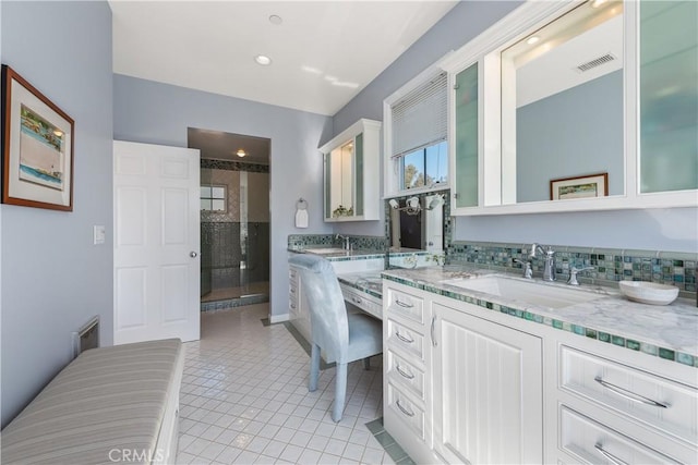 full bathroom featuring vanity, a shower stall, visible vents, and tile patterned floors