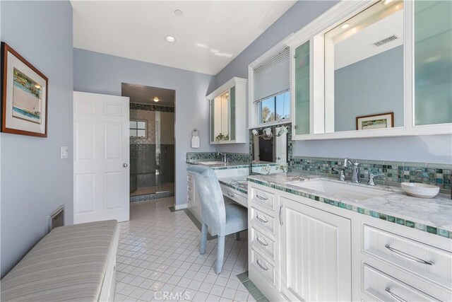 bathroom with a stall shower, tile patterned floors, visible vents, and vanity