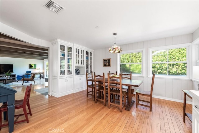 dining space with visible vents and light wood-type flooring