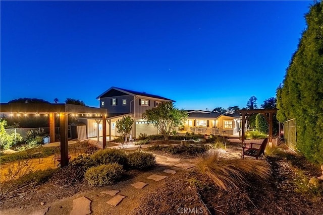 back of house with fence and a pergola