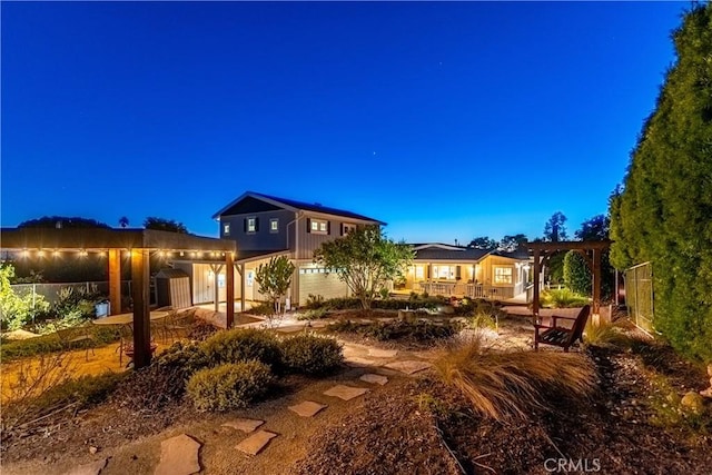 back of house featuring a pergola and fence