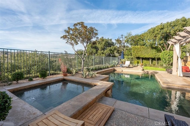 view of swimming pool featuring a fenced in pool, a patio area, a fenced backyard, and an in ground hot tub