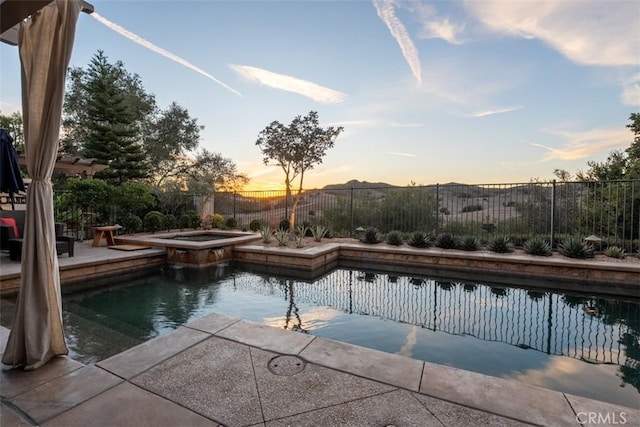 view of swimming pool with a patio area, a fenced backyard, a fenced in pool, and an in ground hot tub