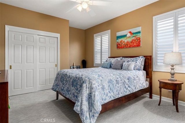 bedroom featuring ceiling fan, a closet, carpet flooring, and baseboards