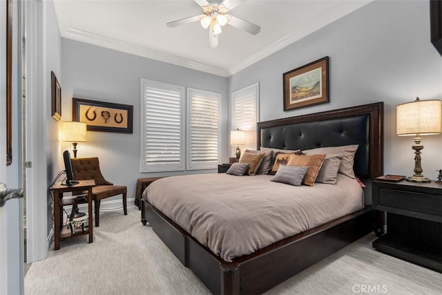 carpeted bedroom with ceiling fan, baseboards, and crown molding