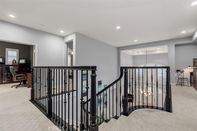 hallway with recessed lighting, carpet flooring, and an upstairs landing