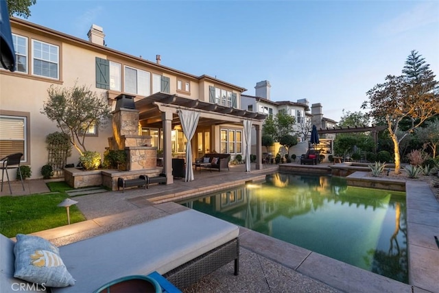 pool with an outdoor living space with a fireplace, a patio area, and a pergola