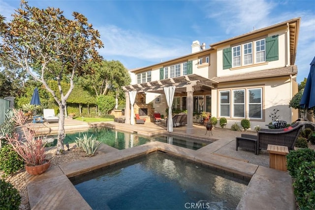 rear view of property with a patio, an in ground hot tub, a pergola, a chimney, and stucco siding