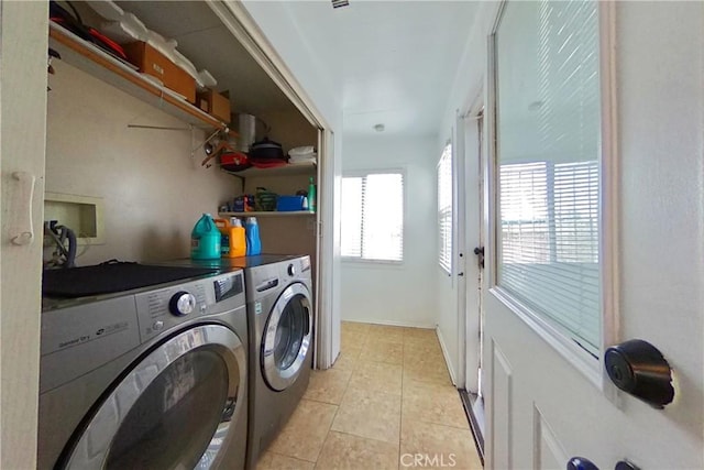 washroom featuring laundry area, light tile patterned flooring, and washer and dryer