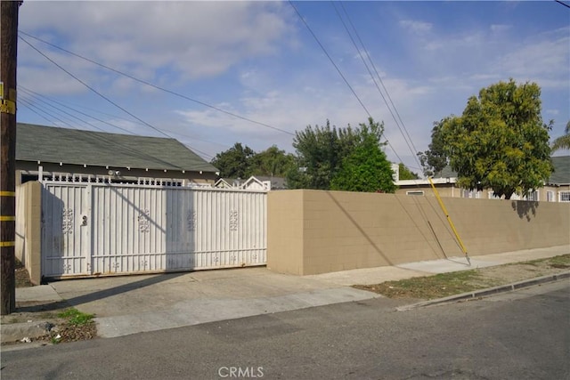 view of gate with a fenced front yard