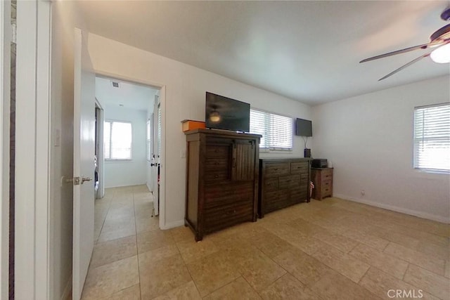 bedroom with visible vents, baseboards, a ceiling fan, and light tile patterned flooring