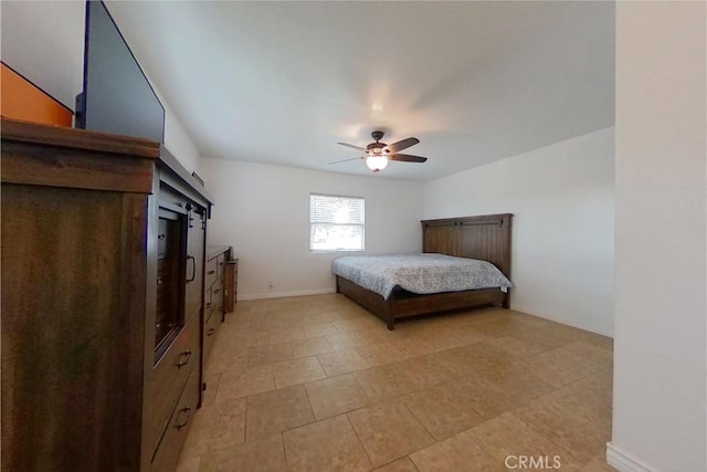 bedroom with ceiling fan and baseboards