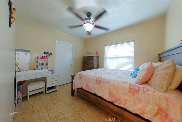 bedroom with light tile patterned floors and a ceiling fan