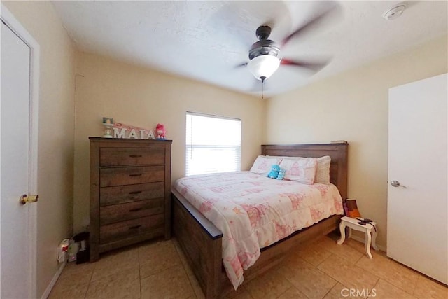 bedroom with light tile patterned floors and ceiling fan