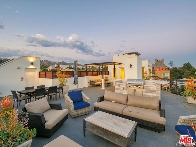 view of patio featuring a grill, an outdoor living space, fence, exterior kitchen, and outdoor dining space