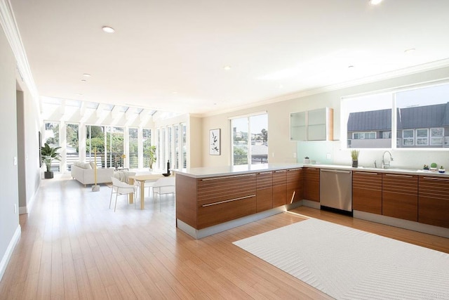 kitchen with a sink, open floor plan, stainless steel dishwasher, brown cabinets, and crown molding