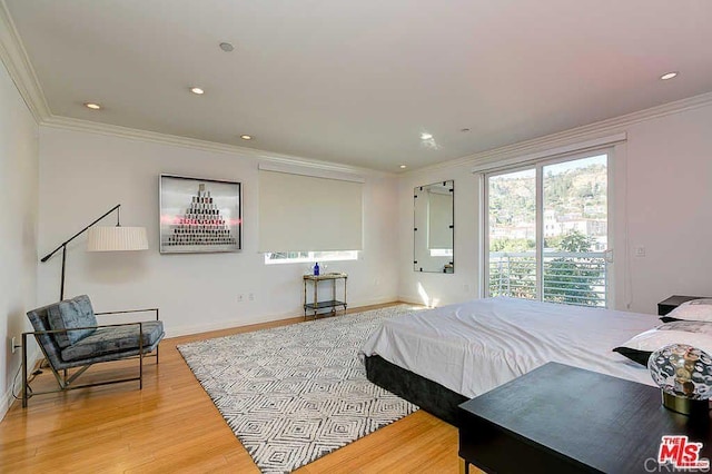 bedroom featuring baseboards, ornamental molding, wood finished floors, and recessed lighting