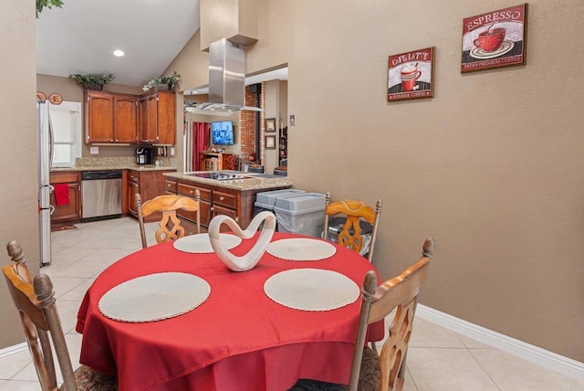 dining room with light tile patterned flooring, baseboards, and lofted ceiling