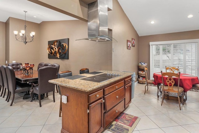 kitchen with an inviting chandelier, lofted ceiling, black electric stovetop, and island exhaust hood