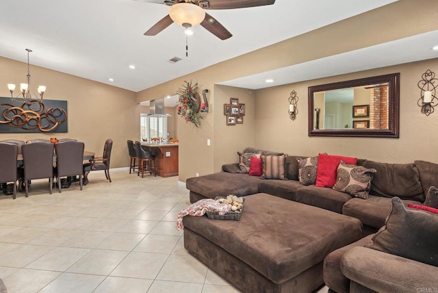 living room with visible vents, lofted ceiling, light tile patterned floors, ceiling fan with notable chandelier, and recessed lighting