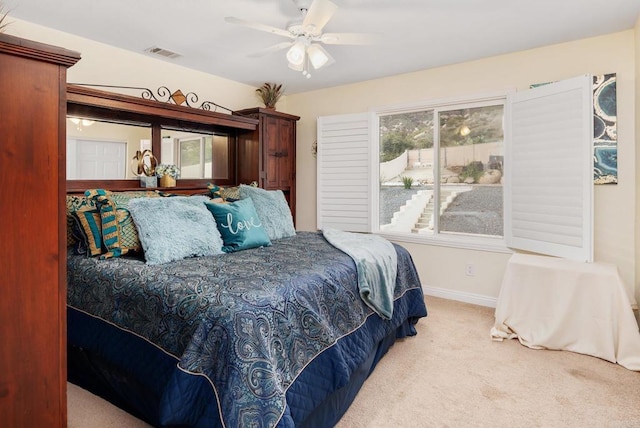 bedroom featuring visible vents, baseboards, carpet, and a ceiling fan