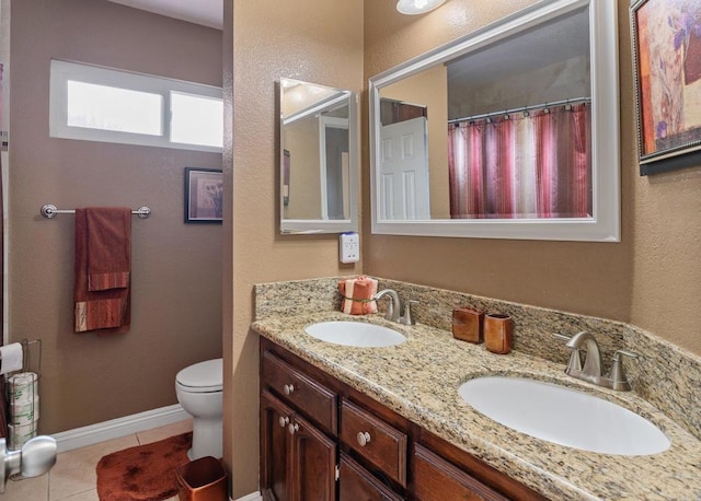 full bathroom featuring a sink, toilet, double vanity, and tile patterned flooring