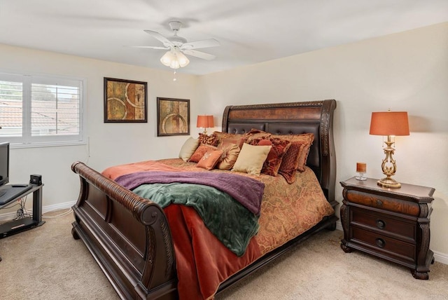 bedroom featuring ceiling fan, baseboards, and light carpet