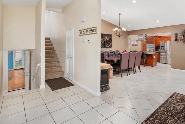 foyer entrance featuring light tile patterned floors, stairway, a chandelier, and recessed lighting