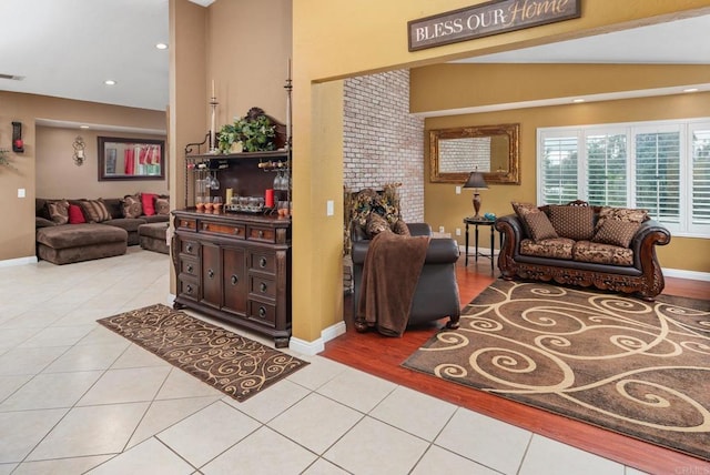 living room featuring light tile patterned floors, recessed lighting, and baseboards