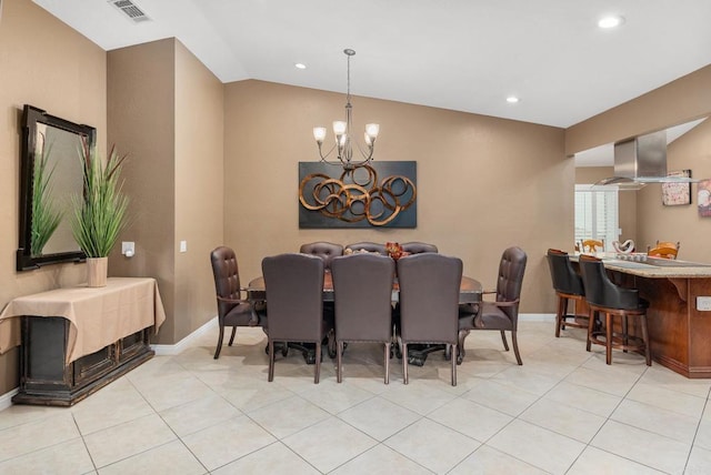 dining room featuring visible vents, baseboards, lofted ceiling, light tile patterned floors, and a notable chandelier