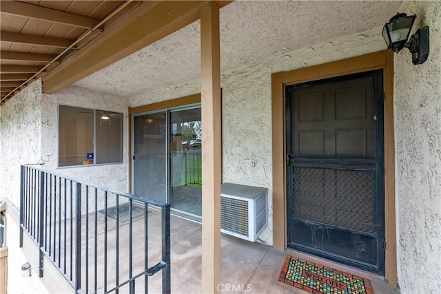 view of exterior entry with stucco siding