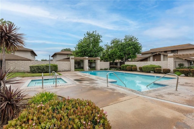 pool featuring a patio area, a community hot tub, and fence