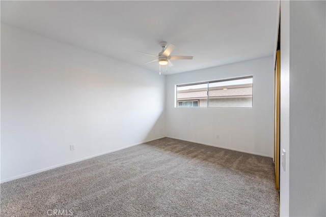 spare room with baseboards, carpet, and ceiling fan