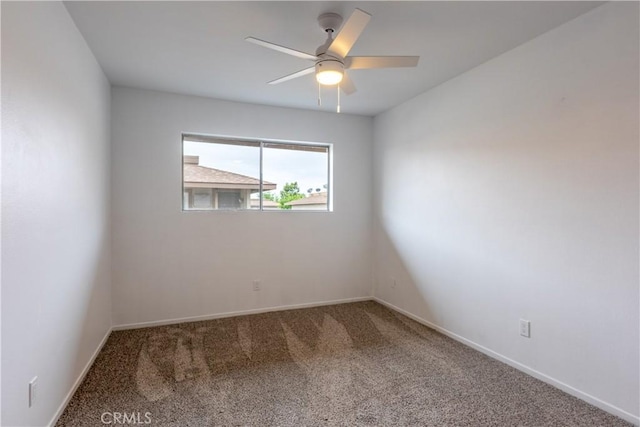 unfurnished room featuring baseboards, carpet floors, and ceiling fan