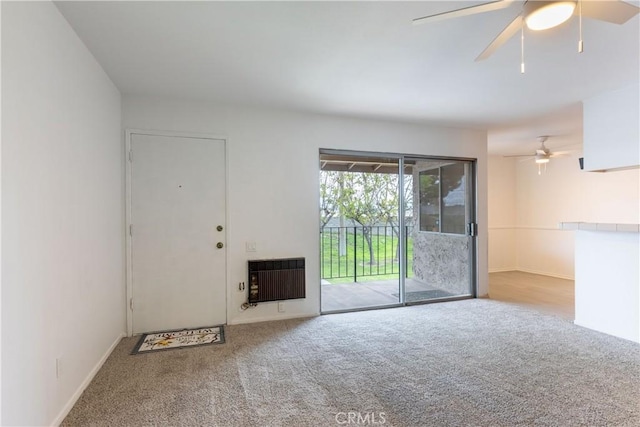 interior space featuring heating unit, carpet, and ceiling fan